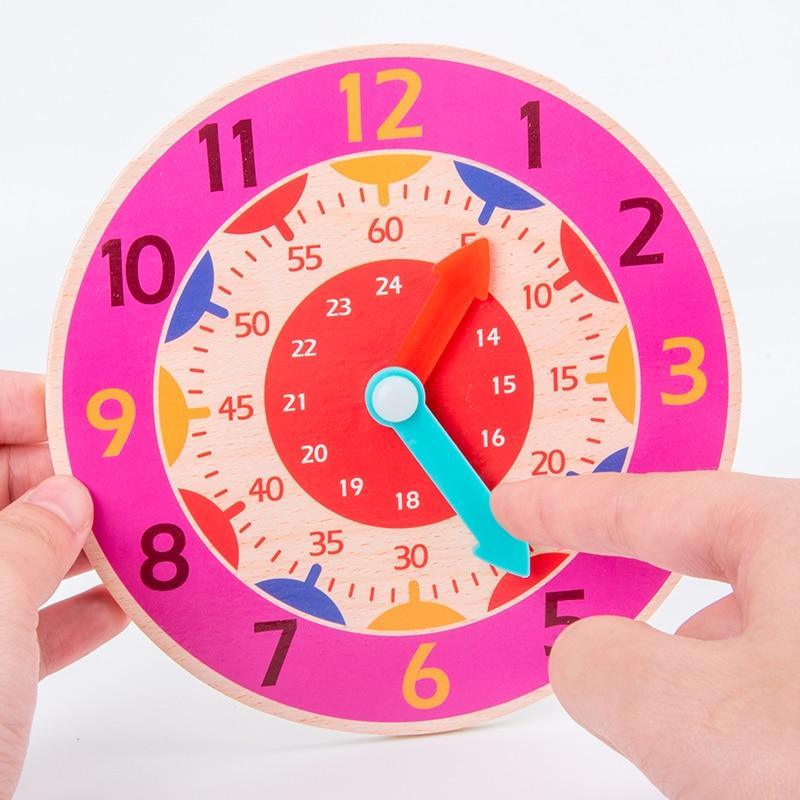 Stevvex wooden clock toy for kids with pink 12-hour outer ring and red hour, blue minute hands on Tampa Home & Garden Store