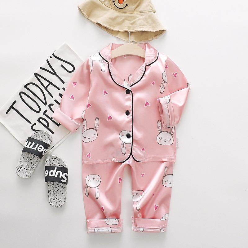 Pink satin Stevvex kids pajama set with bunny prints, button-up top and cuffed pants on Tampa Home & Garden Store