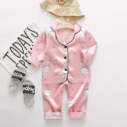 Pink satin Stevvex kids pajama set with bunny prints, button-up top and cuffed pants on Tampa Home & Garden Store
