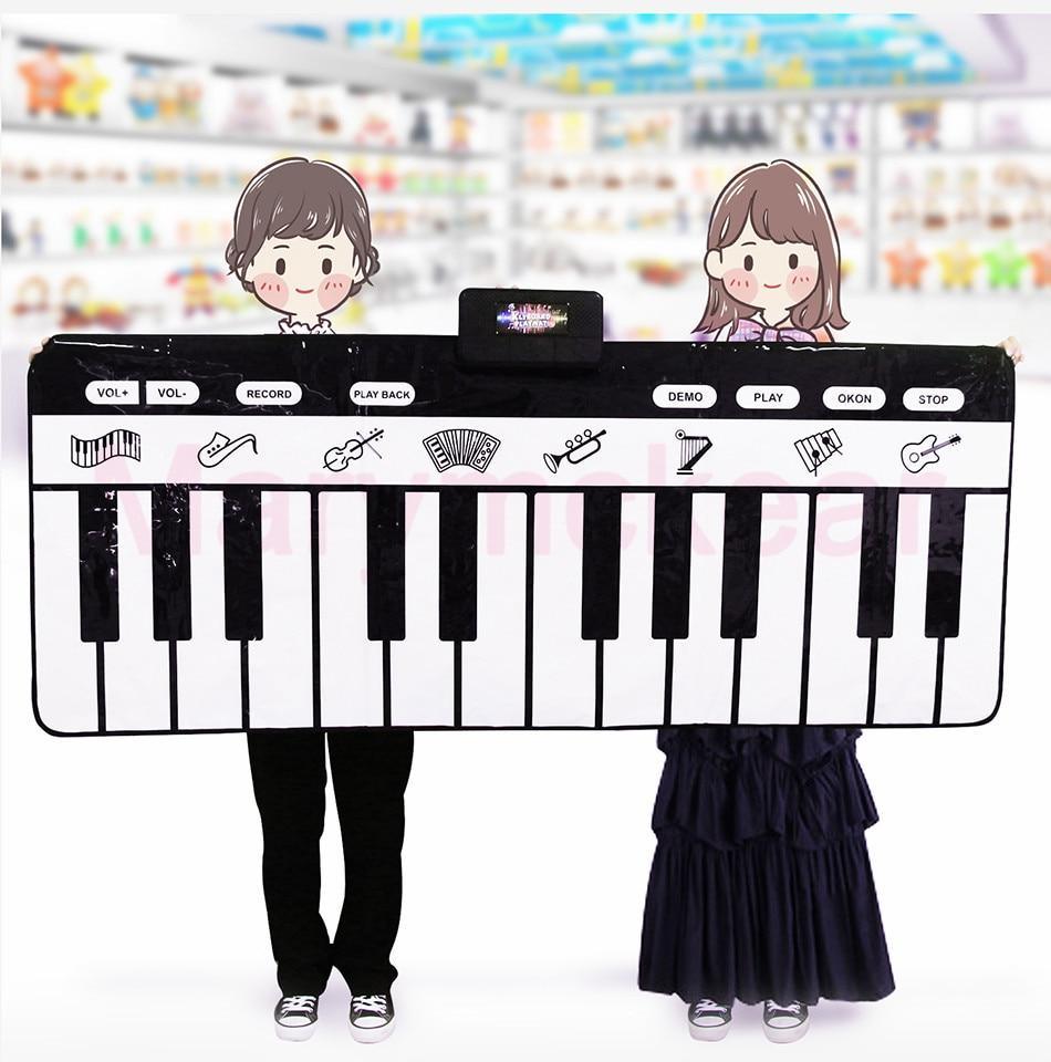 Electronic piano mat keyboard play mat by Stevvex, large black-and-white keys, two kids hold it on Tampa Home & Garden Store