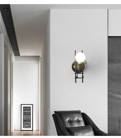 Modern retro doll sconce lamp by Stevvex on black metal ladder with white globe wall light on Tampa Home & Garden Store