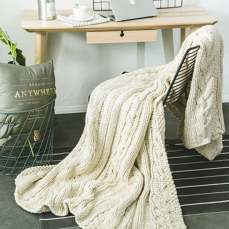 DecorBites Khaki Beige chunky knit wool blanket draped over a black metal chair on Tampa Home & Garden Store
