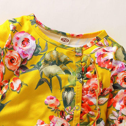 Newborn baby girl floral romper with yellow background and pink blossoms, long sleeves on Tampa Home & Garden Store