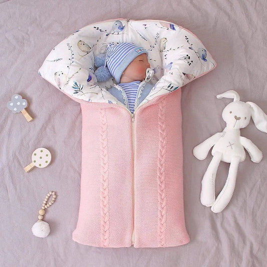 Stevvex newborn knit sleep bag pink with braided trim, baby in blue striped outfit on Tampa Home & Garden Store