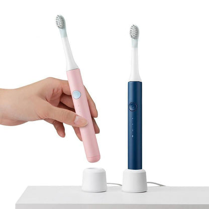Stevvex Sonic Electric Toothbrushes: pink handheld and navy blue model with charging stands on Tampa Home & Garden Store