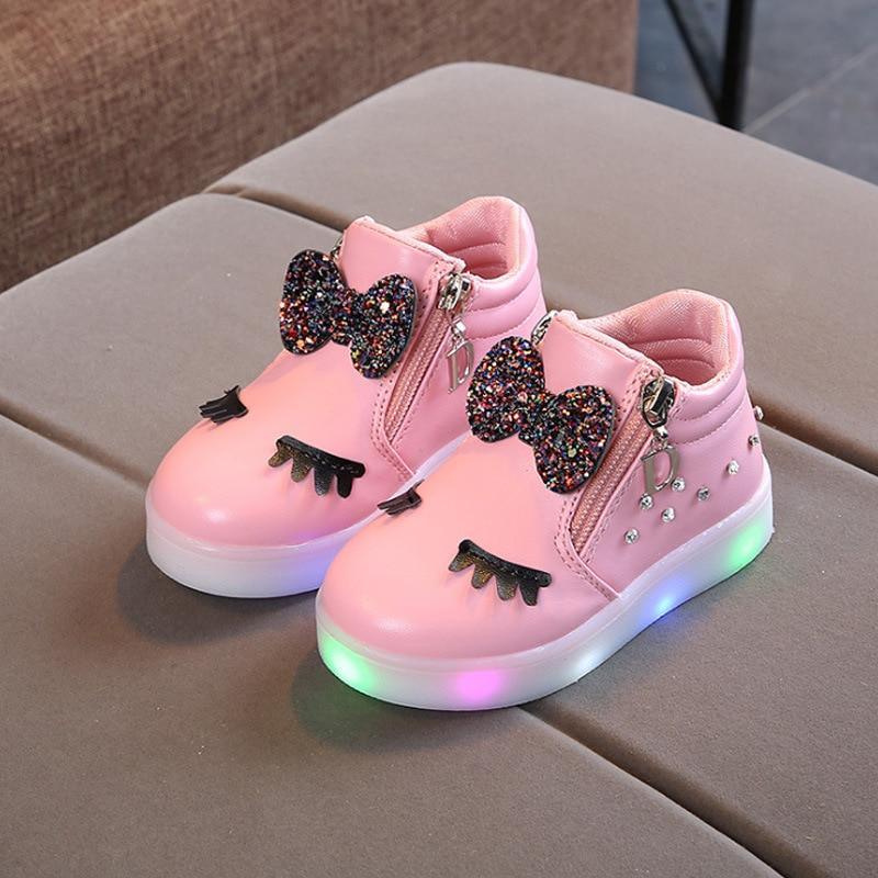 Pair of Stevvex pink glowing LED baby sneakers with glitter bows and rainbow-lit soles on Tampa Home & Garden Store
