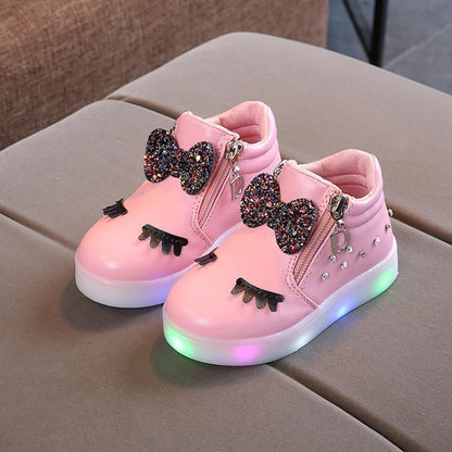 Pair of Stevvex pink glowing LED baby sneakers with glitter bows and rainbow-lit soles on Tampa Home & Garden Store
