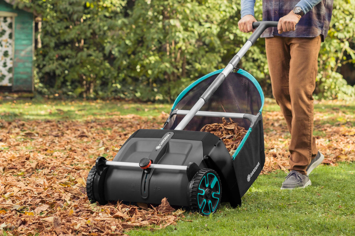 Leaf and Lawn Collector lawn sweeper by Gardena in black with teal accents and large wheels on Tampa Home & Garden Store