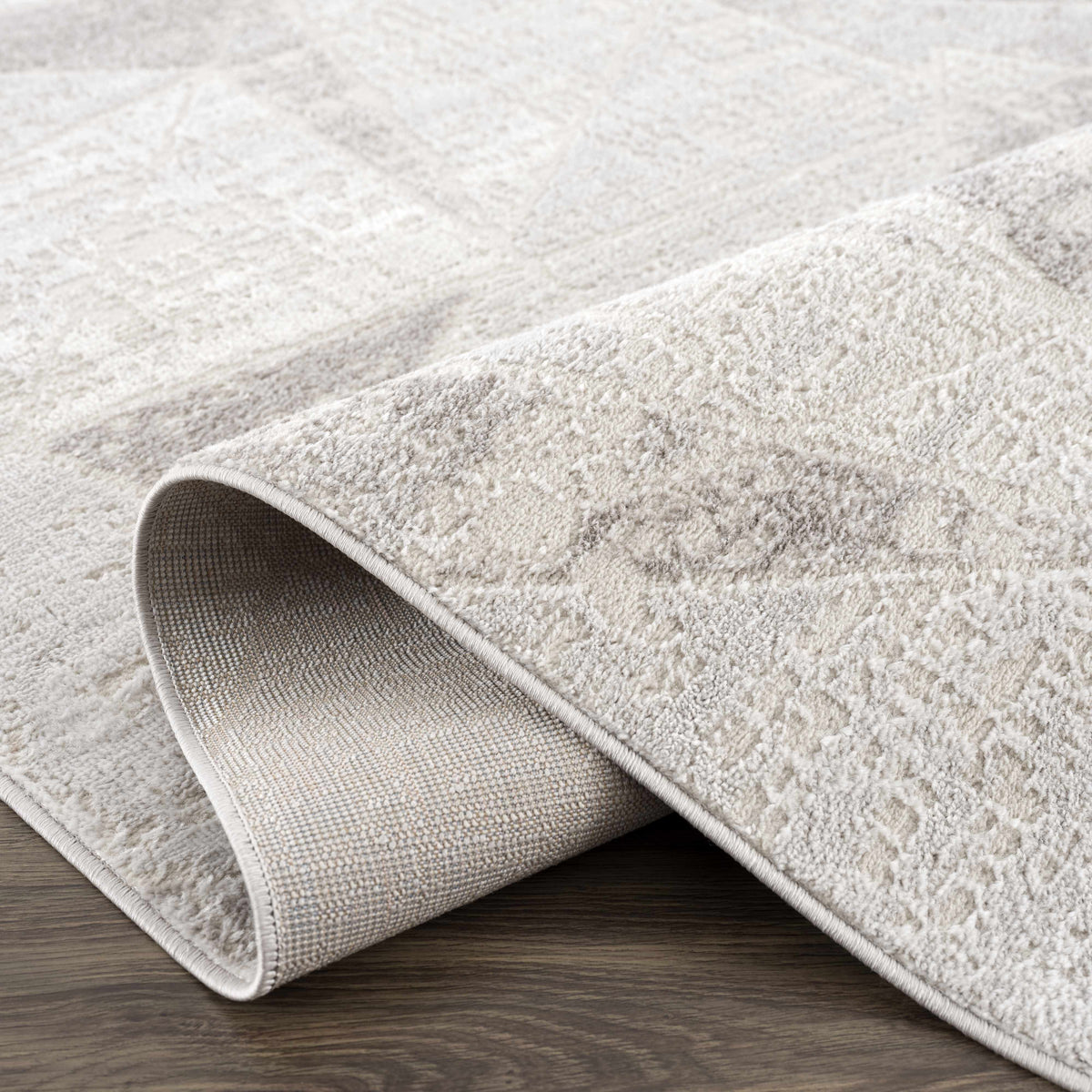 Basia Area Rug Clearance by Boutique Rugs, light beige textured pile, rolled edges visible on Tampa Home & Garden Store
