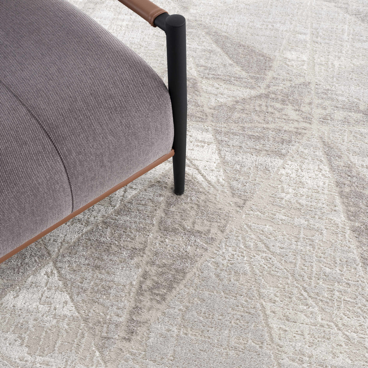 Basia area rug light beige with subtle pattern Boutique Rugs under chair leg on Tampa Home & Garden Store