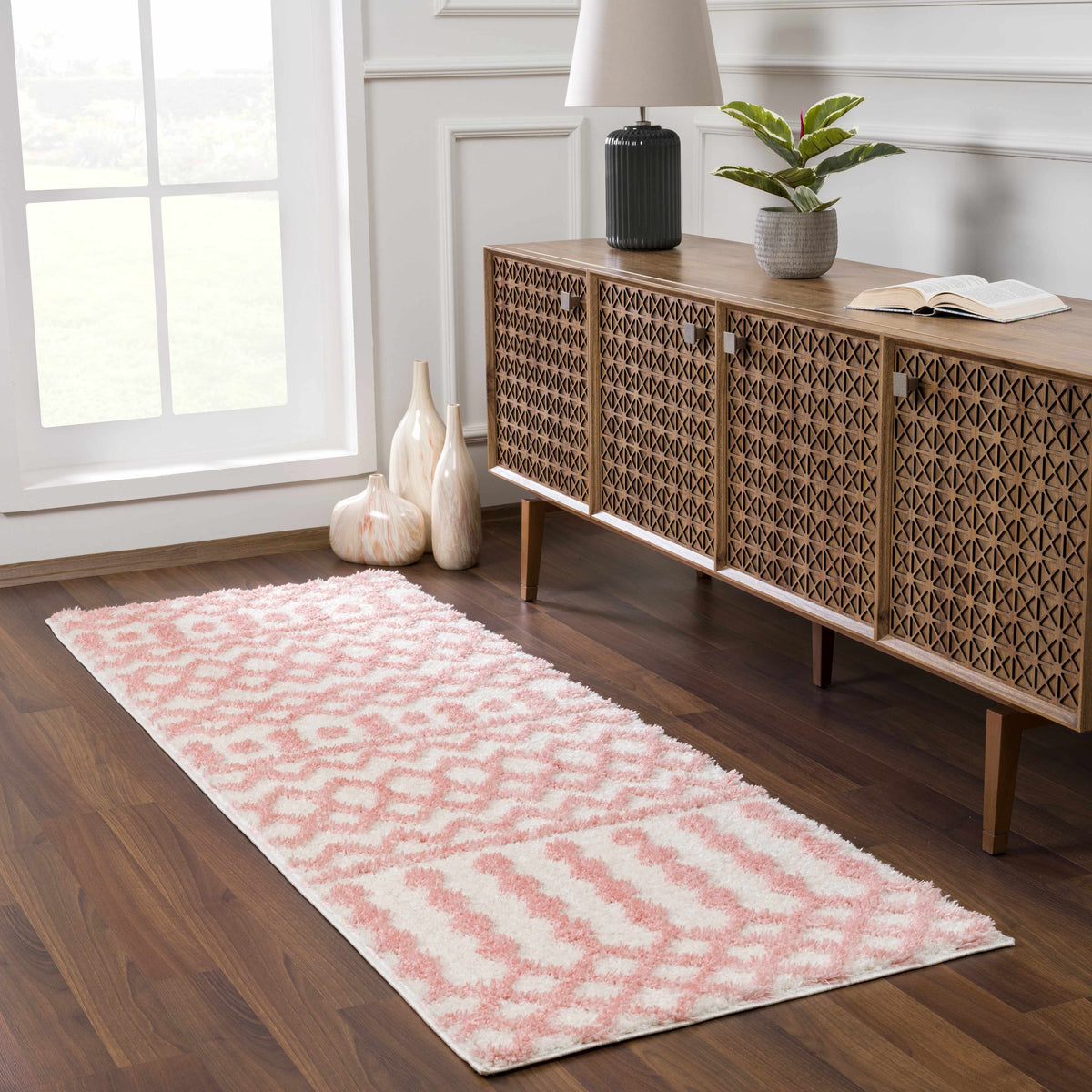 Darva Pink Plush Area Carpet by Boutique Rugs on dark wood floor beside lattice cabinet on Tampa Home & Garden Store