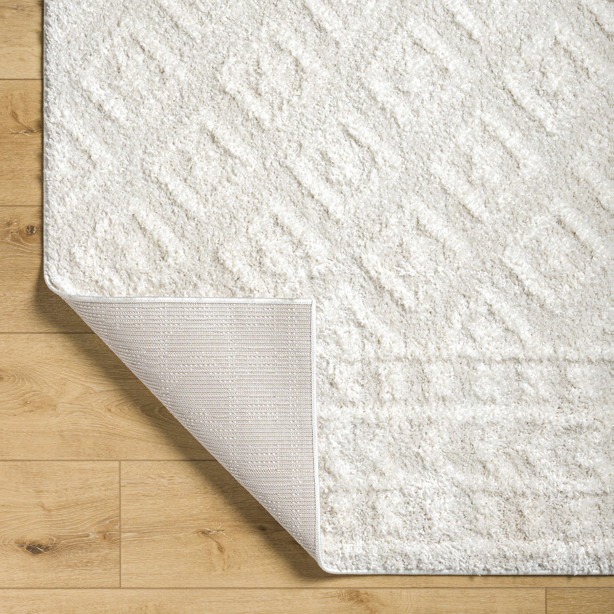 Eivin Cream Diamonds Plush Rug with dense cream shag pile and bound edge on wood floor on Tampa Home & Garden Store
