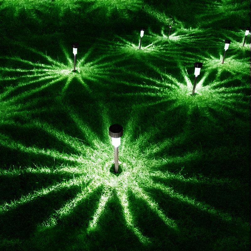 Stevvex garden premium LED solar stainless steel pathway lights casting green glow across lawn on Tampa Home & Garden Store
