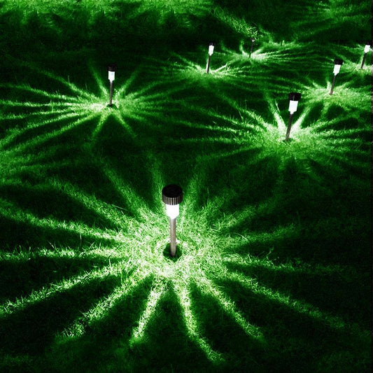 Stevvex garden premium LED solar stainless steel pathway lights casting green glow across lawn on Tampa Home & Garden Store