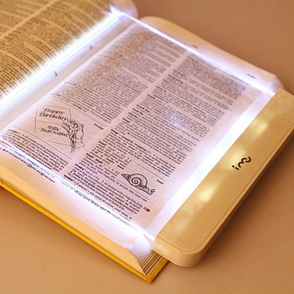 Stevvex Book Light flat LED panel reading lamp portable white glow illuminating an open book on Tampa Home & Garden Store