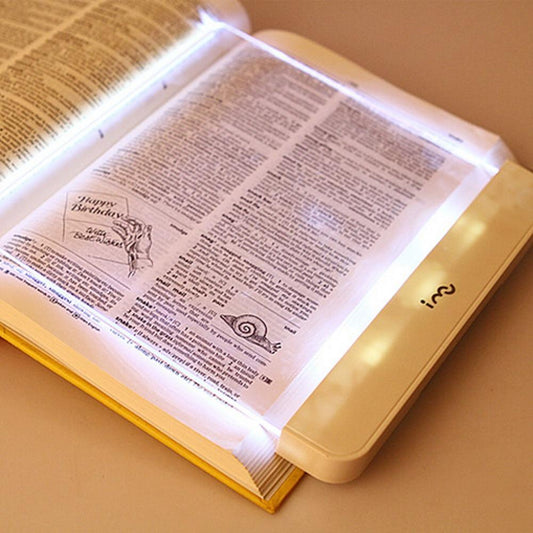 Stevvex Book Light flat LED panel reading lamp portable white glow illuminating an open book on Tampa Home & Garden Store