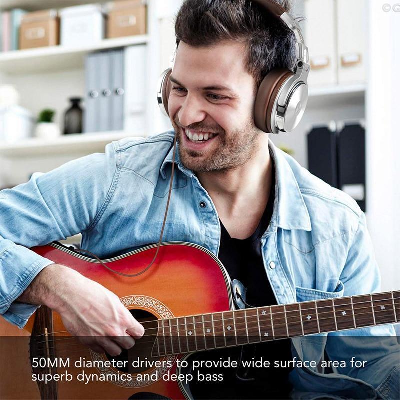 Stevvex DJ Headphones with mic over-ear wired, brown-silver, worn by a man with a red guitar on Tampa Home & Garden Store