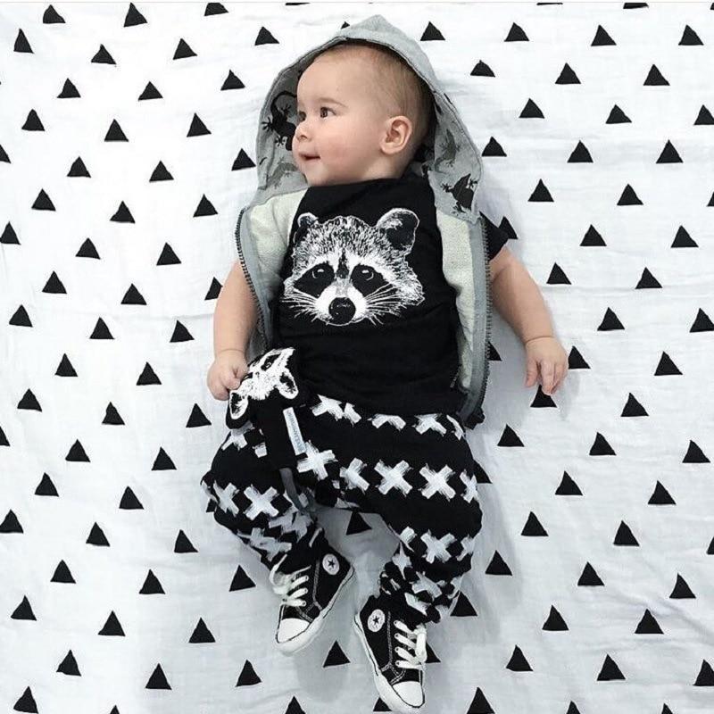 Baby boy T-shirt and pants set by Stevvex with raccoon graphic; black tee, X-pattern pants on Tampa Home & Garden Store