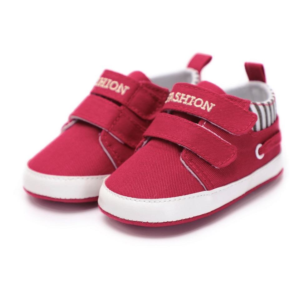 Pair of red canvas first walkers infant sneakers with Velcro straps and white sole on Tampa Home & Garden Store