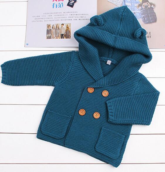 Knitted baby cardigan with hood in teal blue, brown buttons and front pockets on Tampa Home & Garden Store