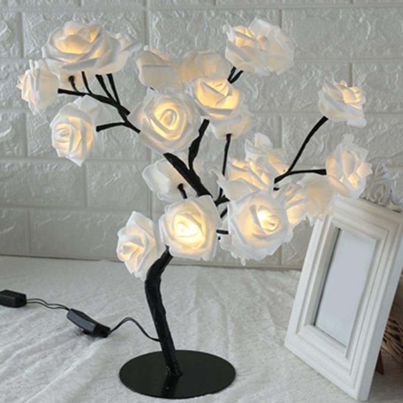 Stevvex rose-shaped table lamp with white rose blossoms and black stem, warm LED lights on Tampa Home & Garden Store