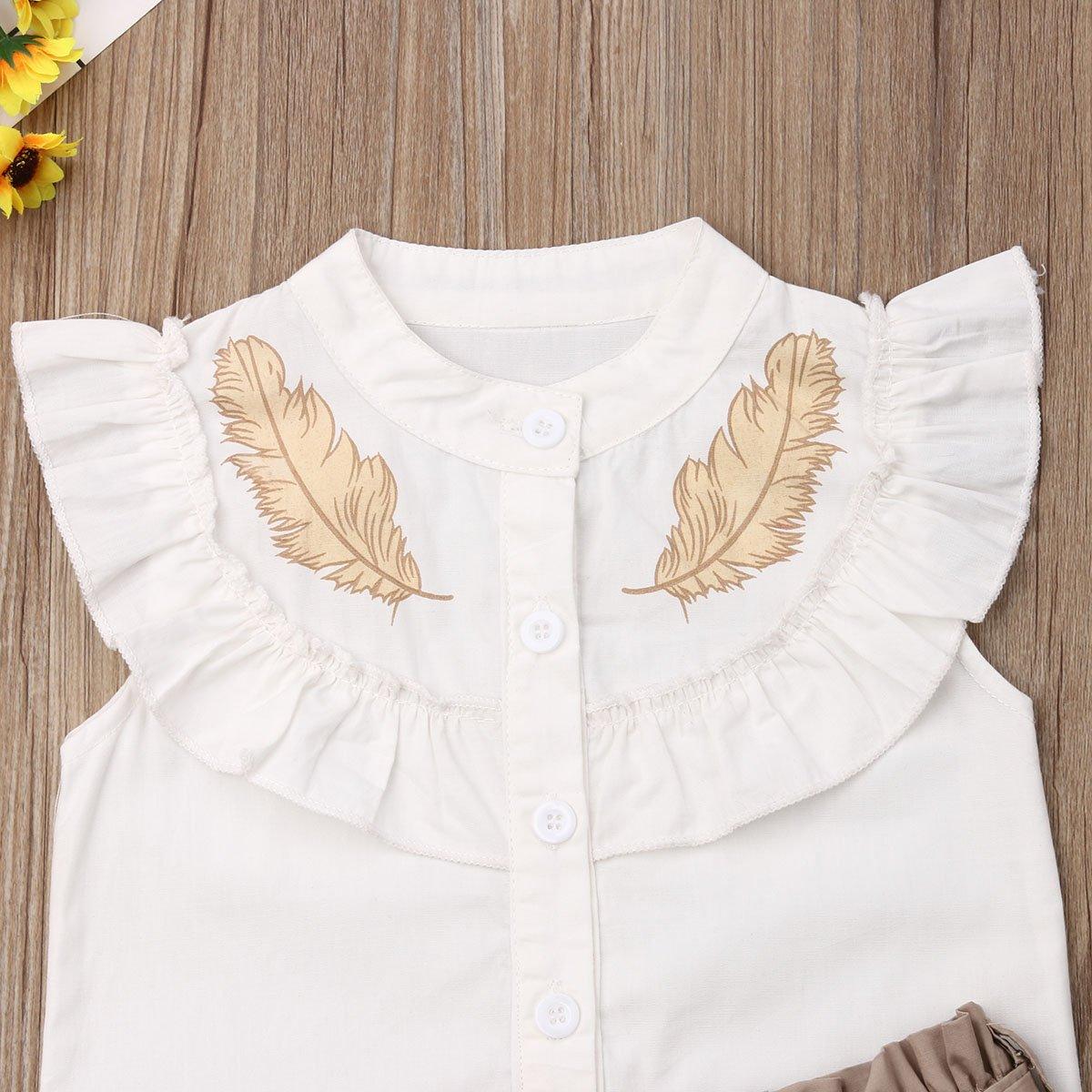 White baby girl sleeveless dress with ruffled bib and beige feather prints, buttoned front on Tampa Home & Garden Store