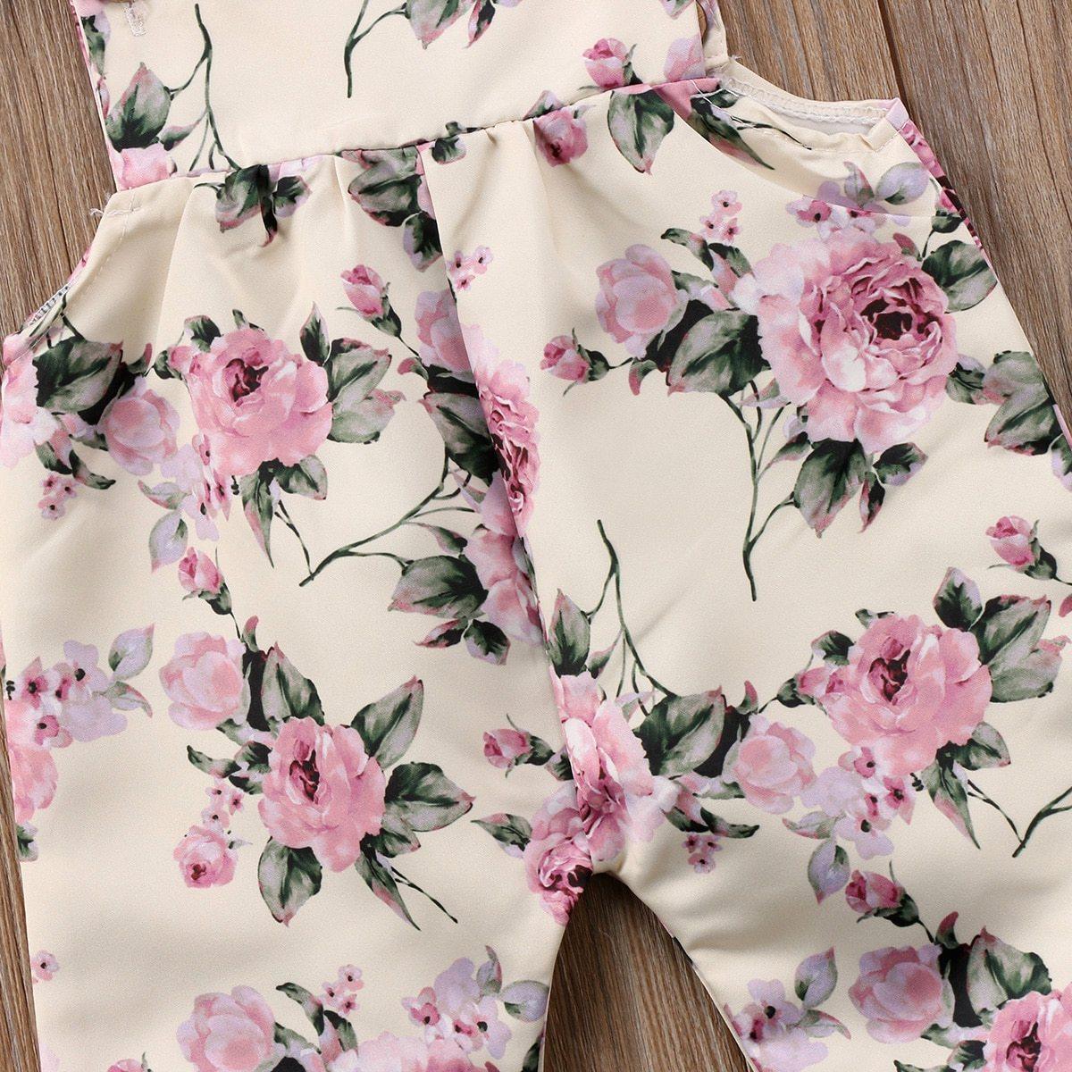 Newborn toddler floral romper jumpsuit with pink roses on cream background, strap ruffle detail on Tampa Home & Garden Store