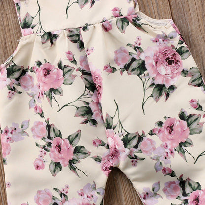 Newborn toddler floral romper jumpsuit with pink roses on cream background, strap ruffle detail on Tampa Home & Garden Store