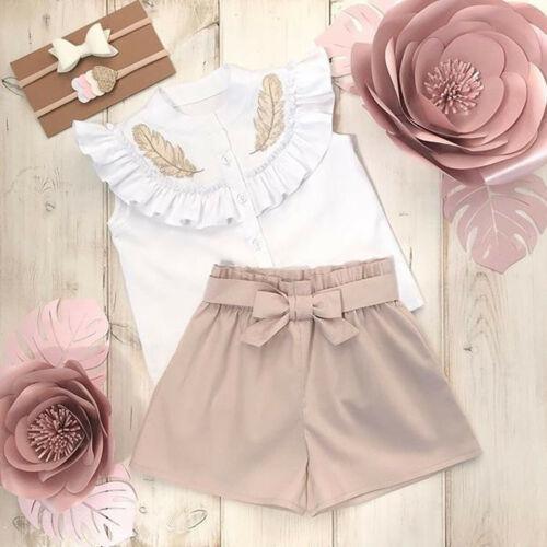 Stevvex baby outfit: white sleeveless top with ruffled collar embroidery; beige shorts with bow on Tampa Home & Garden Store