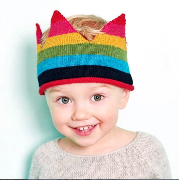 Knitted baby hat Stevvex rainbow stripes with red brim on a smiling newborn on Tampa Home & Garden Store