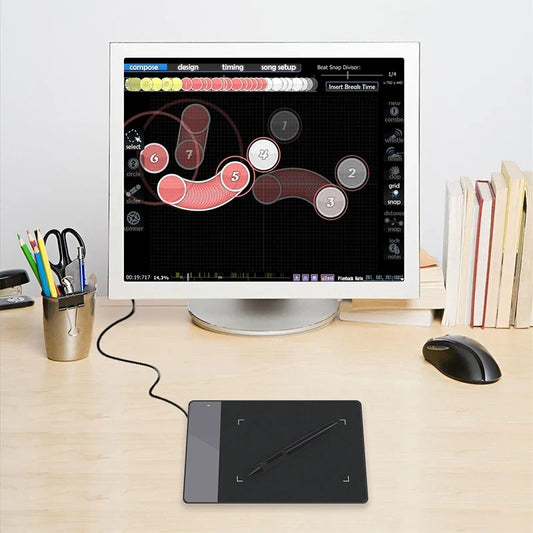 HUION 420 4-Inch USB pen tablet with stylus on a desk beside a monitor and books on Tampa Home & Garden Store