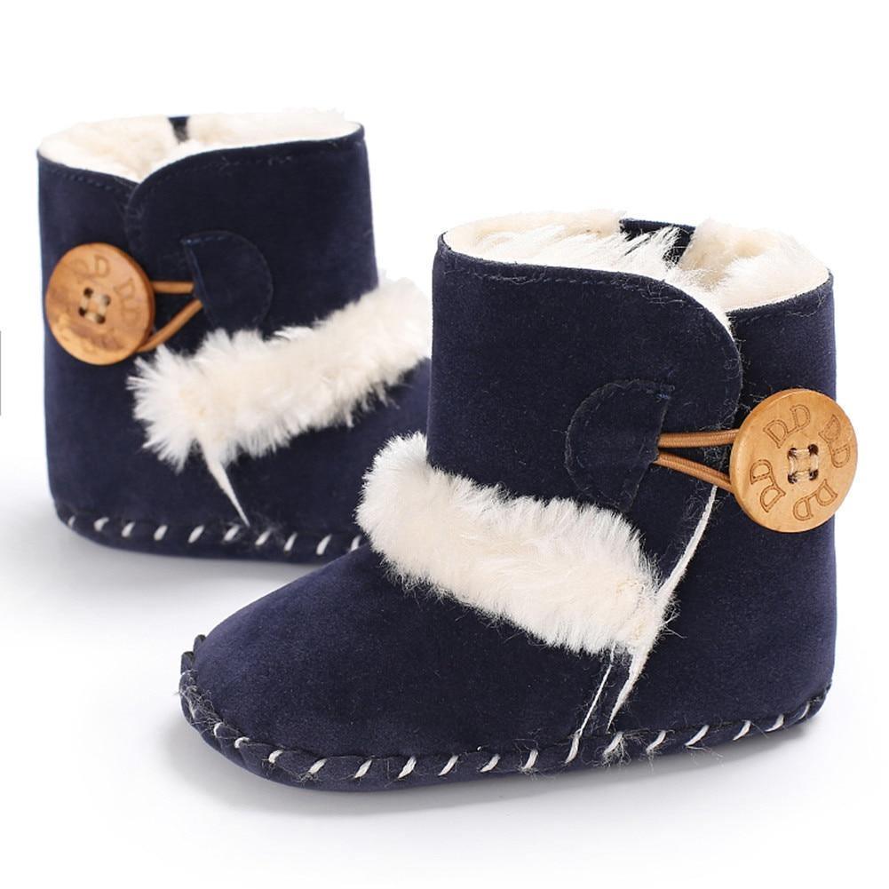 Stevvex navy newborn snow boots pair with white faux fur trim and wooden button closure on Tampa Home & Garden Store