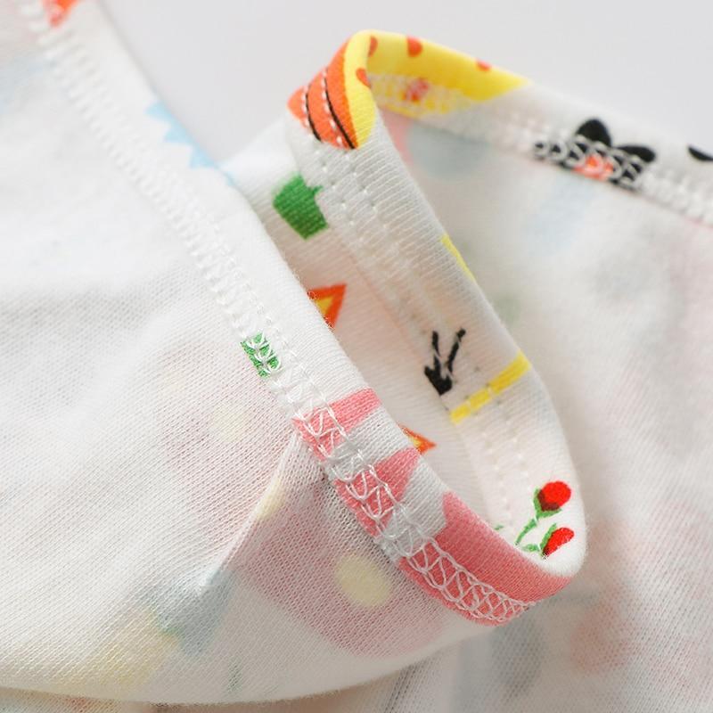 Newborn swaddle blanket close-up: white fabric with colorful prints and pink bound edge on Tampa Home & Garden Store