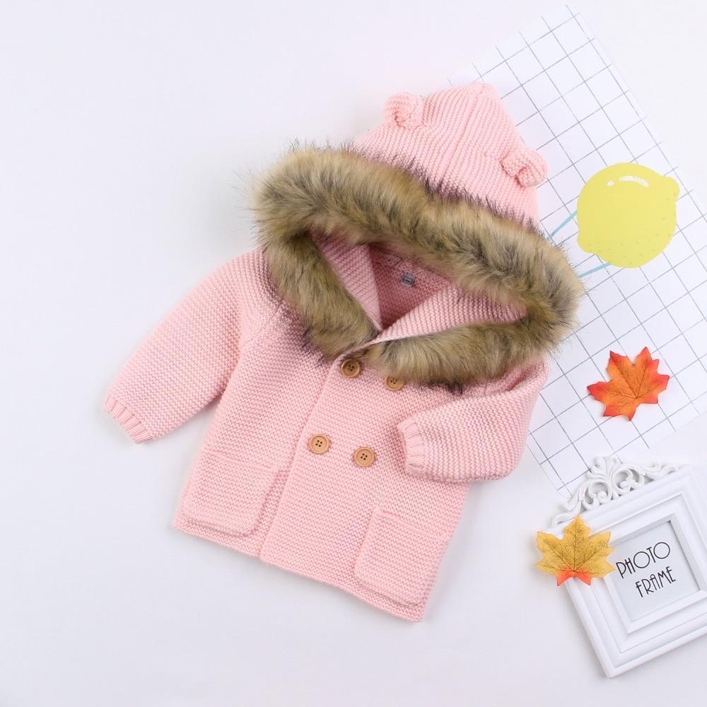 Pink knit baby cardigan with fur-lined hood, button front and front pockets on Tampa Home & Garden Store
