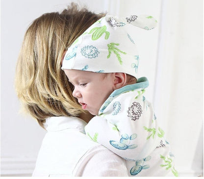 Stevvex baby swaddle blanket with cap in white with green-blue accents, infant in hooded wrap on Tampa Home & Garden Store