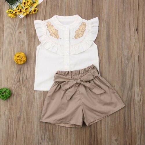 Stevvex baby girl outfit: white sleeveless top with ruffle and embroidery, beige bow shorts on Tampa Home & Garden Store