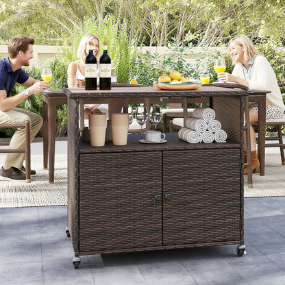 Outdoor storage cabinet with acacia wood top by DirectDeals in wicker, two wine bottles on top on Tampa Home & Garden Store