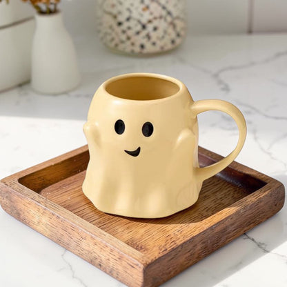 Ghost Mug by Gia Roma in pale yellow ghost design with a friendly face on a wooden tray on Tampa Home & Garden Store