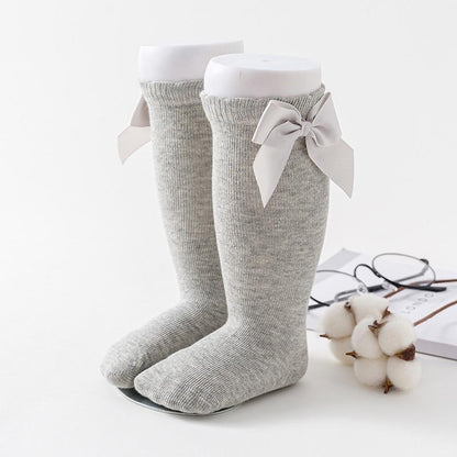 Baby girls knee-high socks pair by Stevvex, soft gray cotton knit with a large bow on Tampa Home & Garden Store