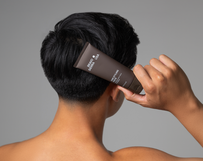 Bravo Sierra hair styling paste tube held against the back of dark hair on Tampa Home & Garden Store