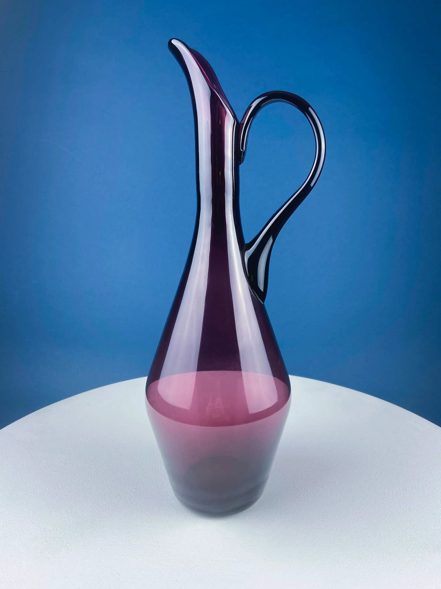 Hand blown purple glass pitcher vase with a curved handle, elegant centerpiece on Tampa Home & Garden Store