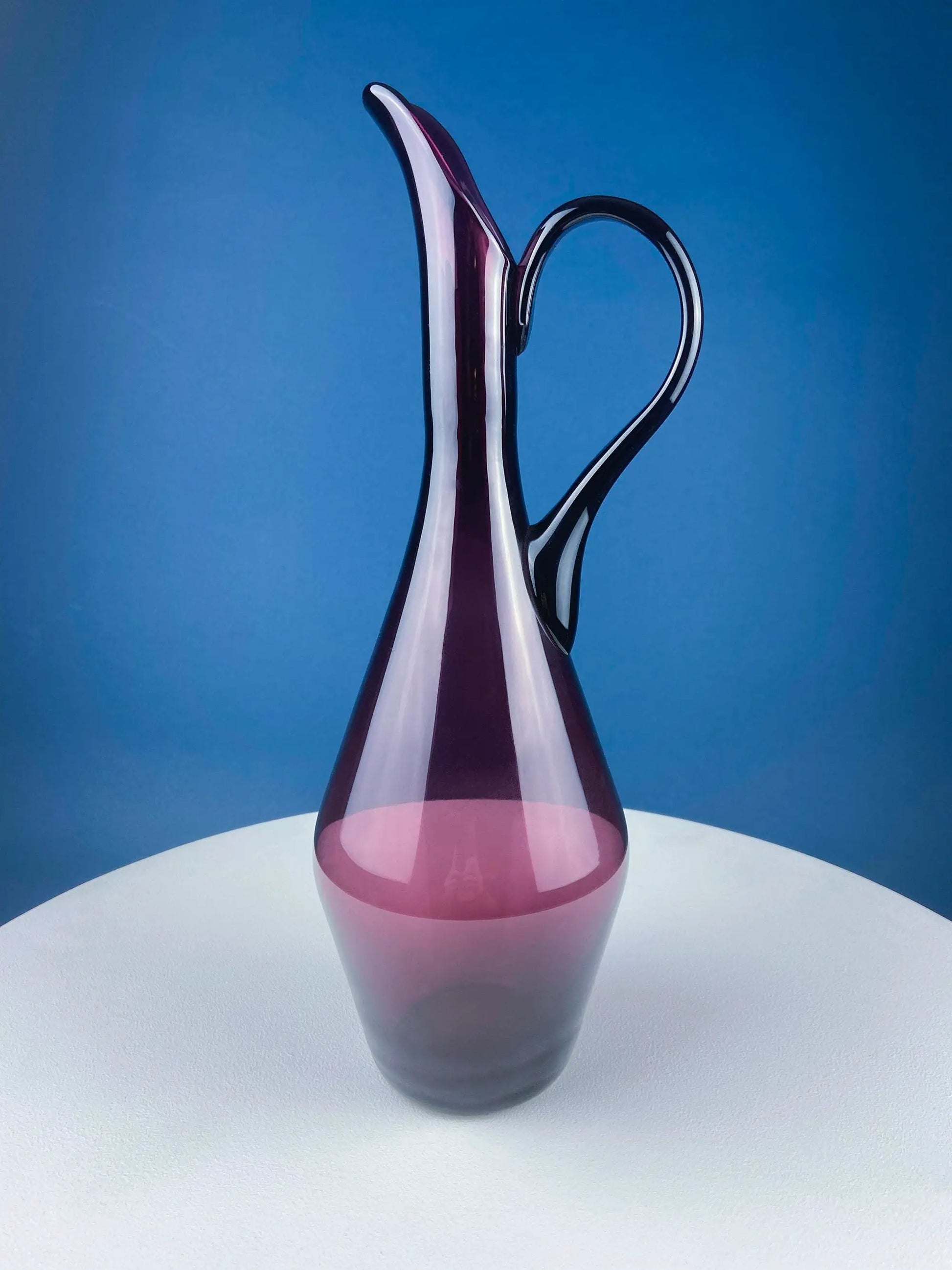 Hand blown purple glass pitcher vase with a curved handle, elegant centerpiece on Tampa Home & Garden Store