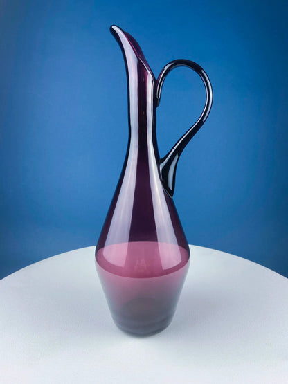 Hand blown purple glass pitcher vase with a curved handle, elegant centerpiece on Tampa Home & Garden Store
