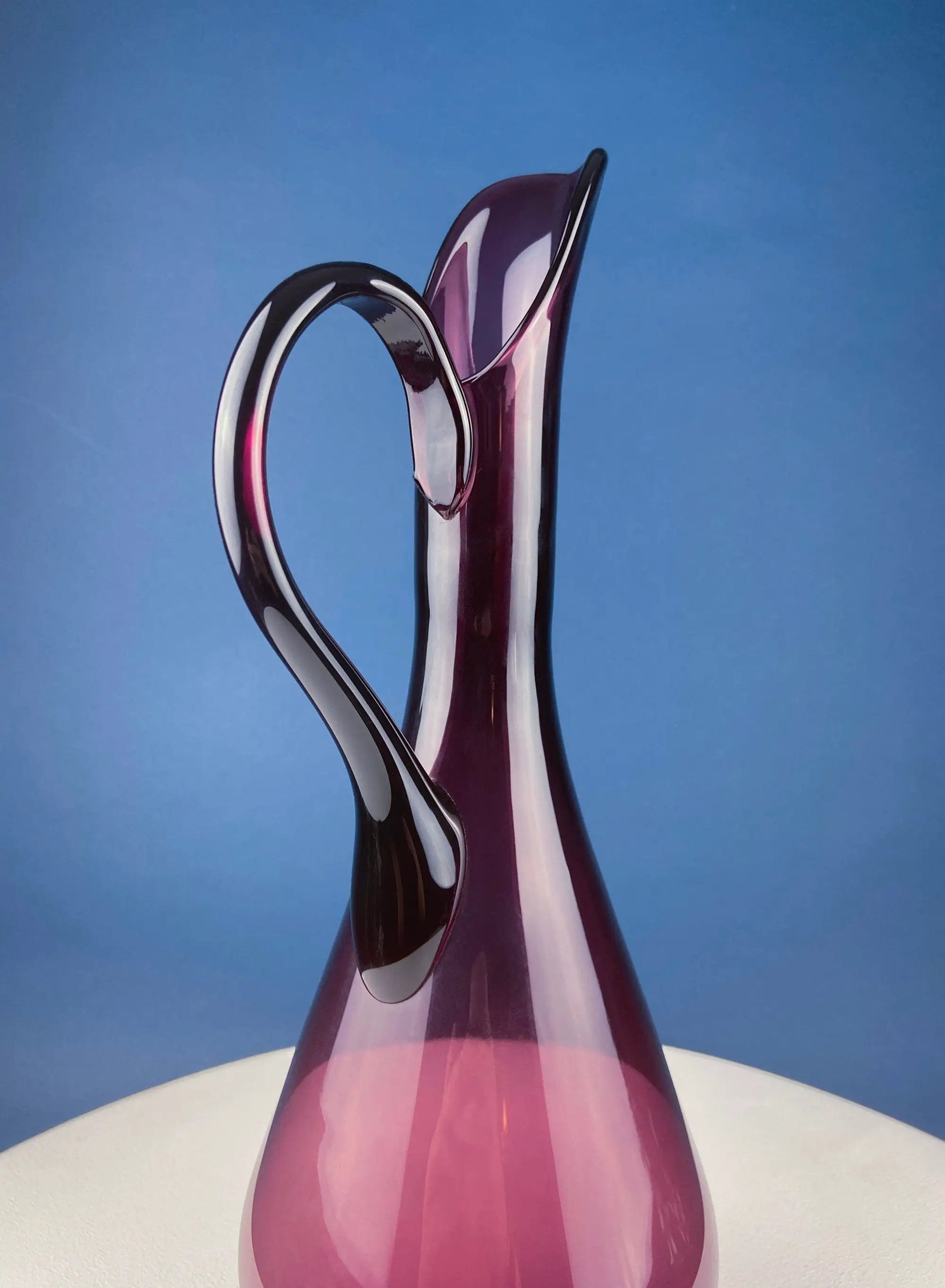 Hand blown purple glass pitcher vase centerpiece with a looping handle and pink gradient on Tampa Home & Garden Store