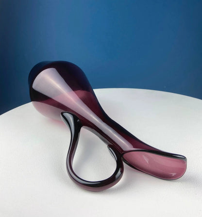 Hand blown purple glass centerpiece vase sculpture with looping curves on white surface on Tampa Home & Garden Store