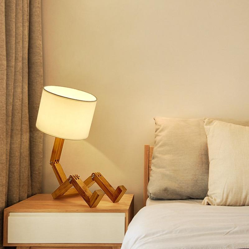 Table lamp Stevvex ST5LM45021BBG wooden robot-folding lamp with warm cream shade beside bed on Tampa Home & Garden Store