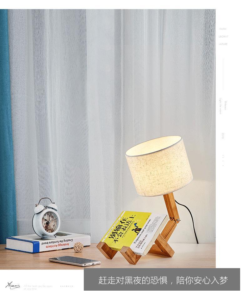 Stevvex robot-shape folding wooden table lamp with beige linen shade on a desk beside books on Tampa Home & Garden Store