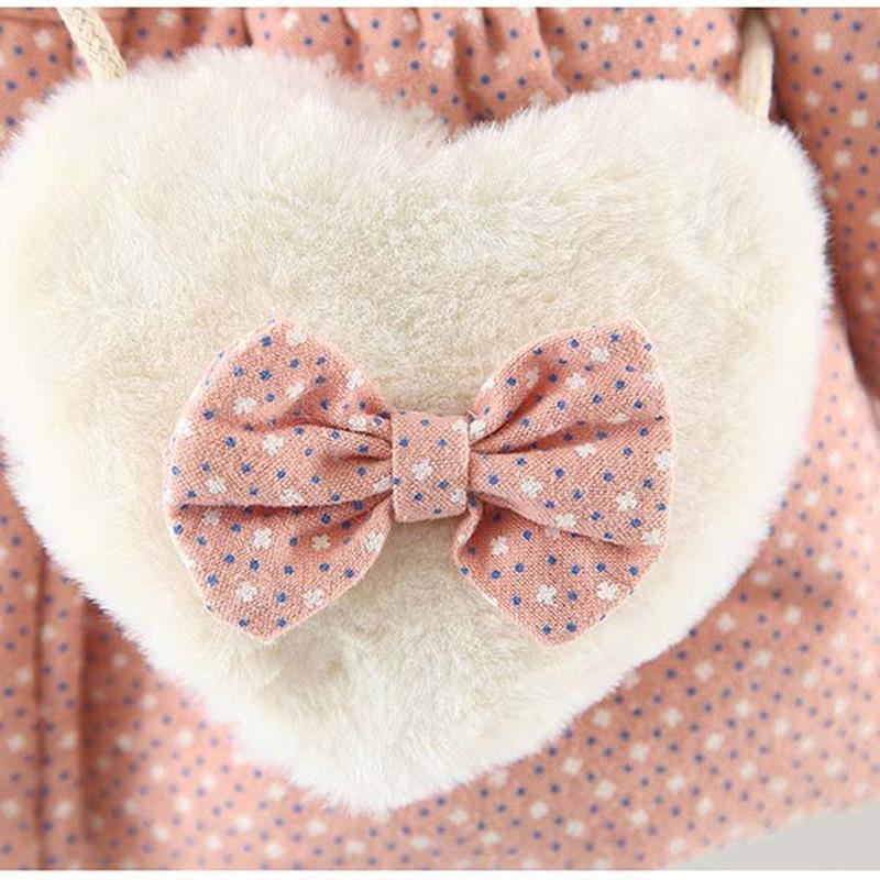 Newborn baby girl jacket with plush heart applique and pink dotted bow on peach fabric on Tampa Home & Garden Store
