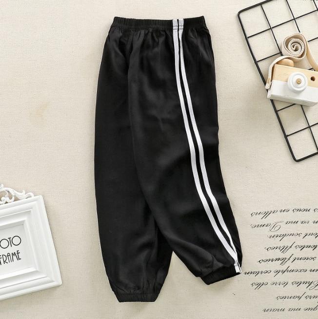 Stevvex kids black sports pants with white striped sides, elastic waistband and cuffs on Tampa Home & Garden Store