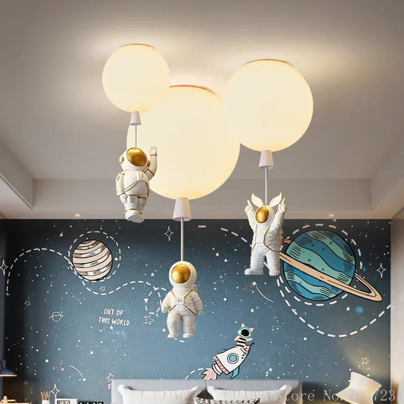DecorBites Kids Space Balloon LED Ceiling Lamp with three hanging astronauts, soft warm glow on Tampa Home & Garden Store